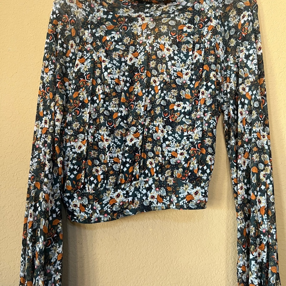Green/white/orange floral print top.